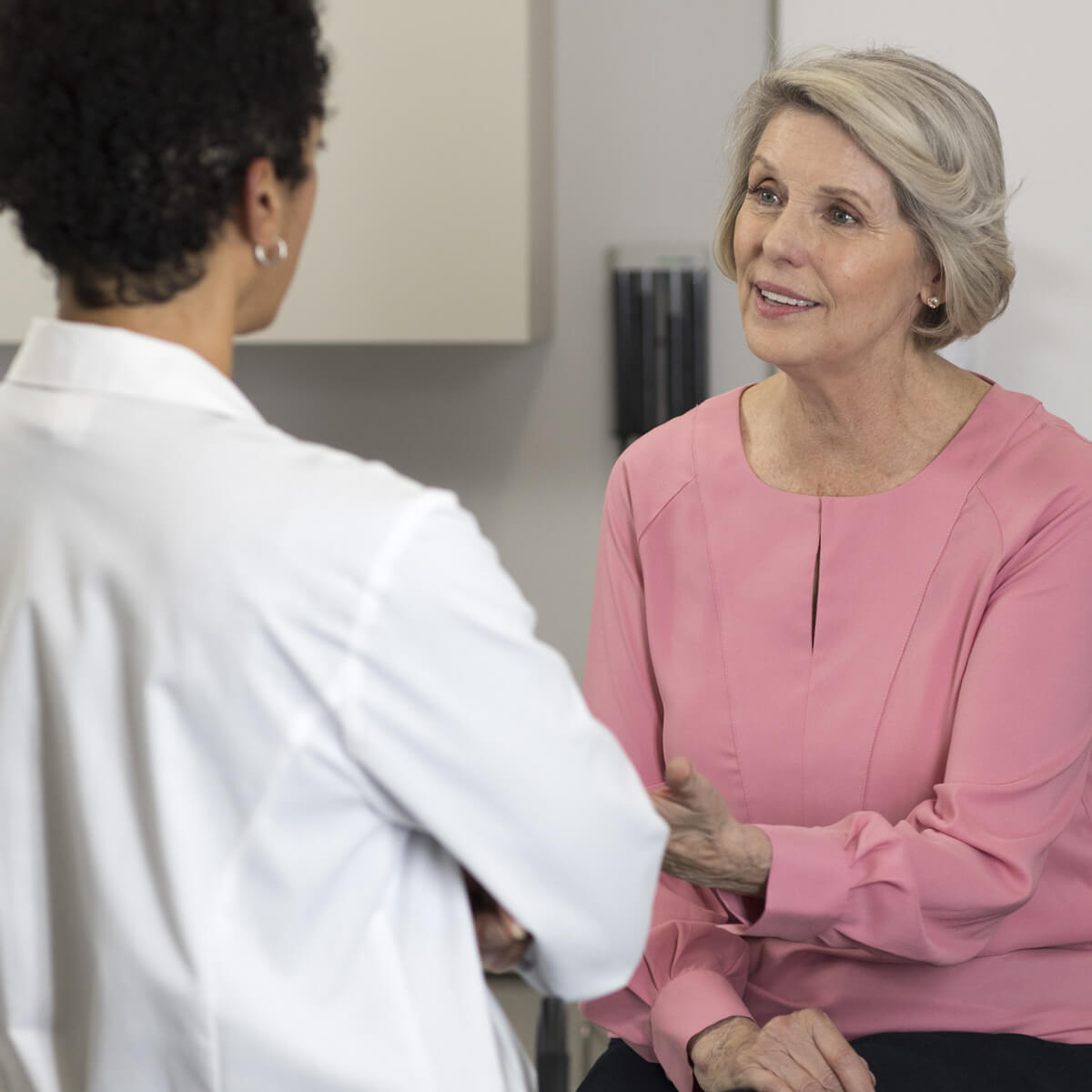 A physician discusses health opportunities based on data from the Care Decision Insight program with a patient.
